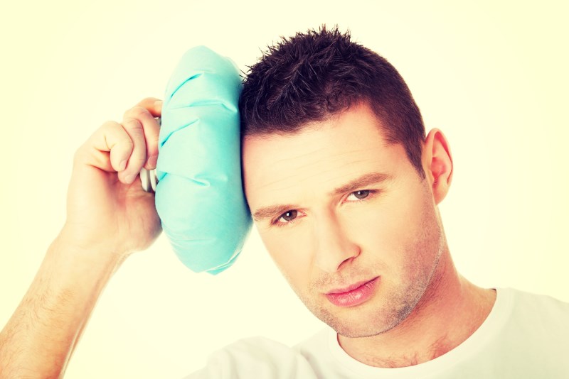 Man with ice bag for headaches, migraines ,hangover and injury