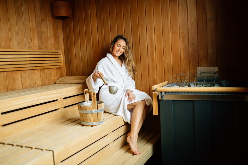 Beautiful woman in finnish sauna caring about health and skin