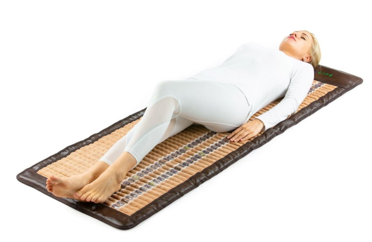Woman laying on a HealthyLine far infrared mat