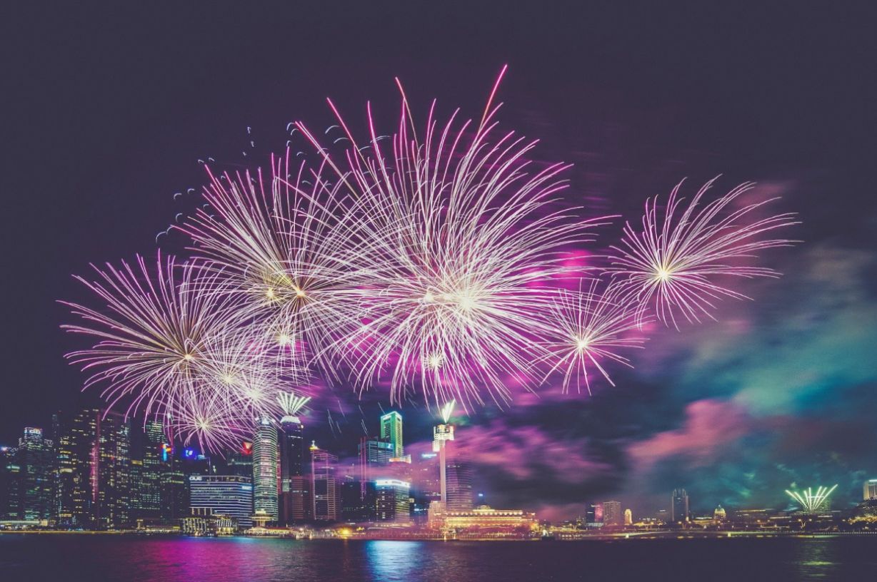 New Year’s fireworks glowing brightly over a city