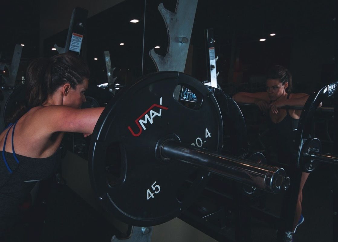 Woman working out at a smith machine