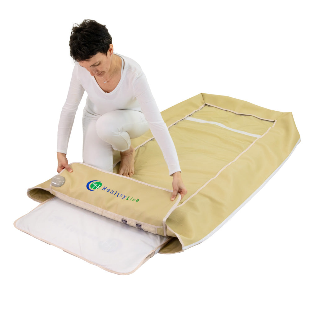 Woman assembling HealthyLine Platinum 7428 Wrap Set by layering a tan SOFT gemstone mat over a silver Platinum photon mat.
