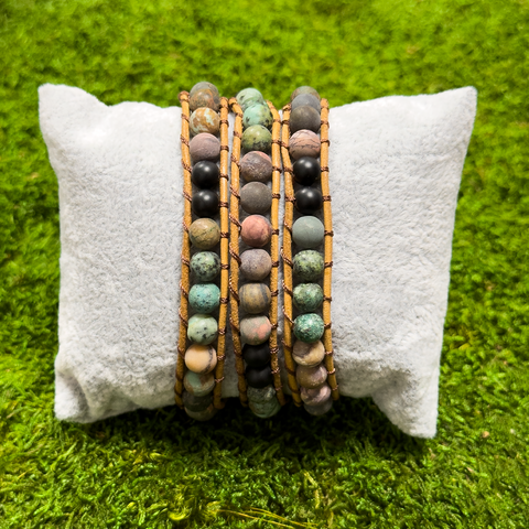 Multi-stone wrap bracelet featuring matte Turquoise and Onyx beads displayed on a jewelry pillow.