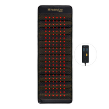 HealthyLine Jet Pro+ 74x28 inch PEMF mat, the widest size, laid upright with red photon lights glowing across the full dark surface, Gen 4 controller shown to the side