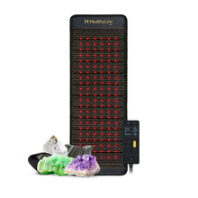 HealthyLine Jet Series 72x24 inch PEMF mat in dark fabric with grid of glowing red photon lights, shown with Gen 4 controller and natural gemstones including amethyst, jade, obsidian, and quartz crystal