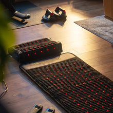 HealthyLine Jet Mat 7224 and Jet Pillow on a floor, both featuring glowing red light therapy points.