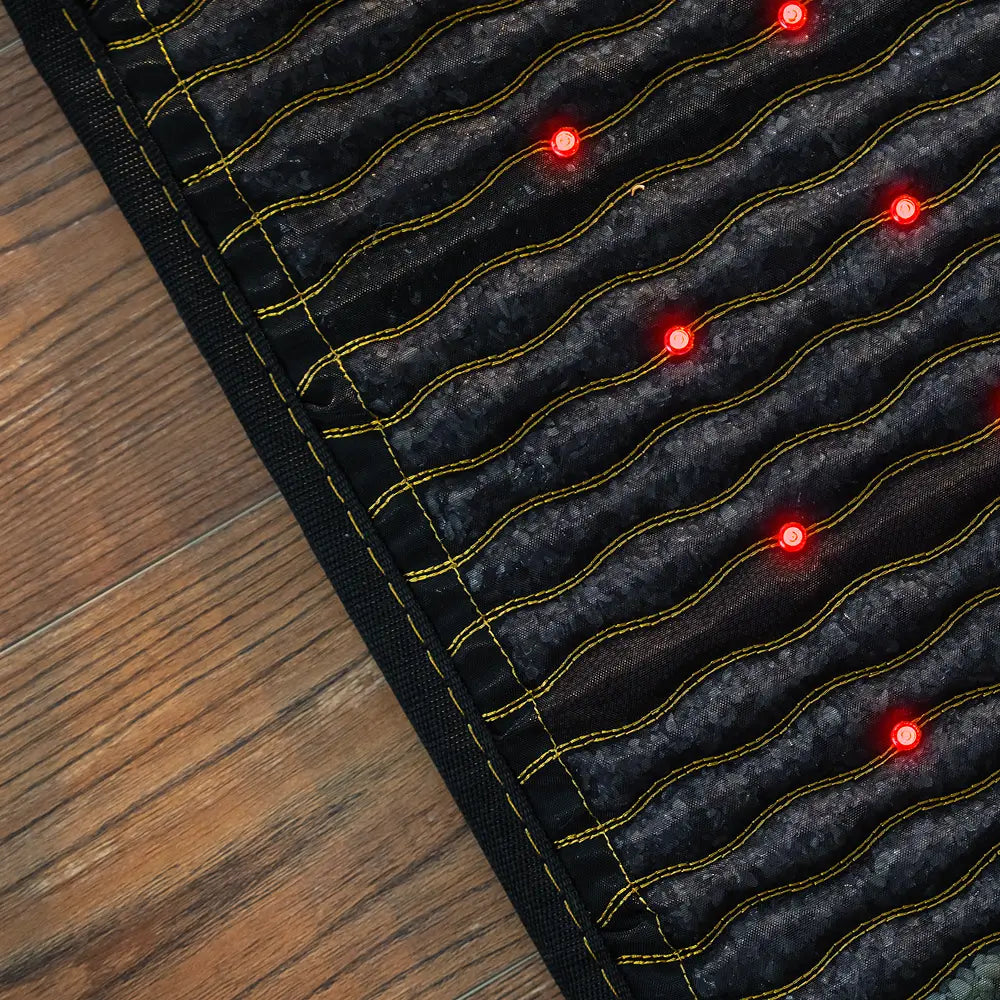 HealthyLine Jet 72x24 inch PEMF mat showing the full-length dark gemstone surface with rows of red photon lights and gold wave-pattern channels