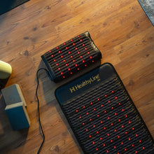 HealthyLine Jet 72x24 inch PEMF mat laid flat showing the full dark textured surface with red photon lights embedded in a wave-pattern gemstone layer