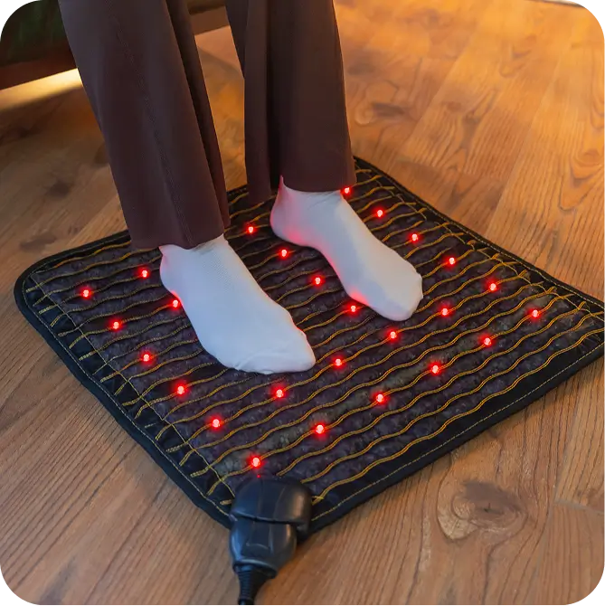 Person standing on the Jet mat 20x20 used as a foot pad with red light therapy LEDs illuminated