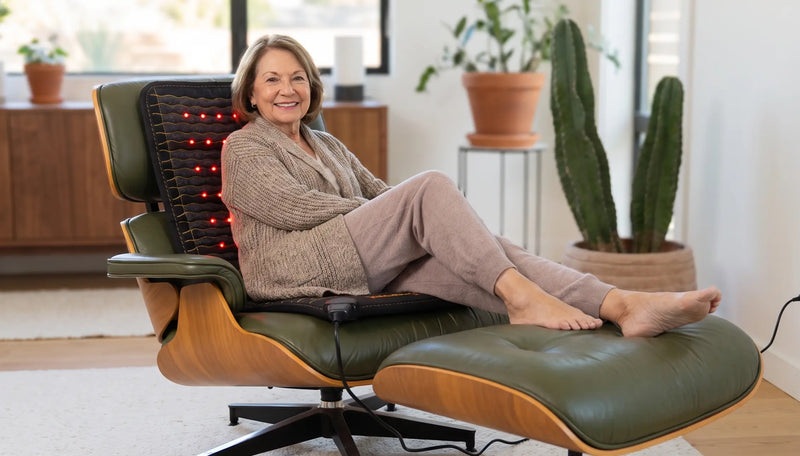 Smiling older woman relaxing in a lounge chair with a Jet mat lining the seat and backrest.
