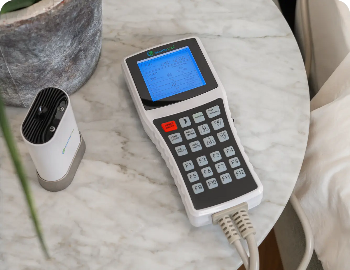 HealthyLine Platinum Advanced Controller with LCD screen, heat and PEMF function buttons, on a marble table