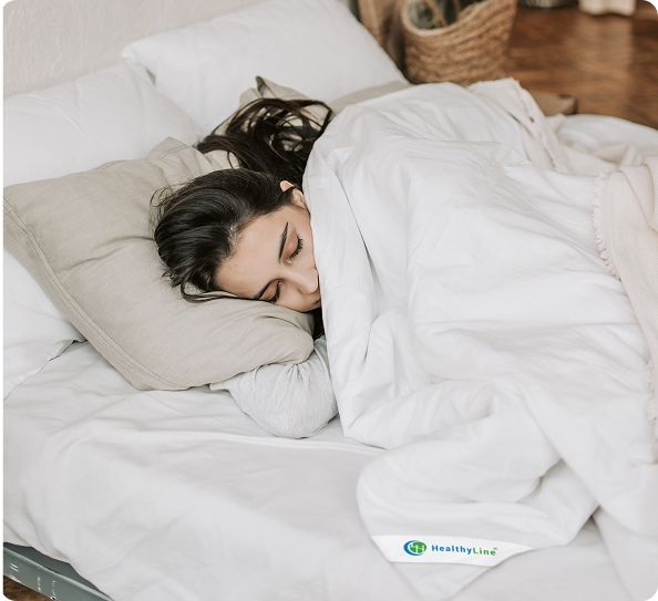 Person sleeping under HealthyLine Comforter