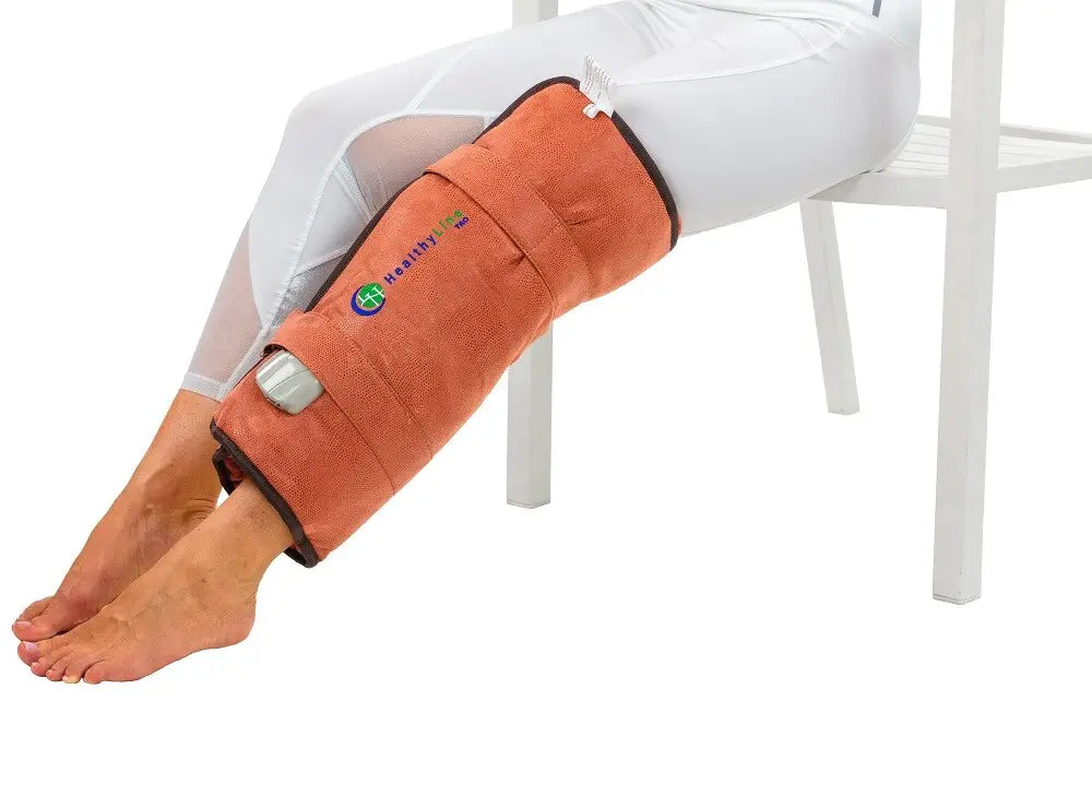Person seated with the TAO Hand wrap secured around their lower leg

