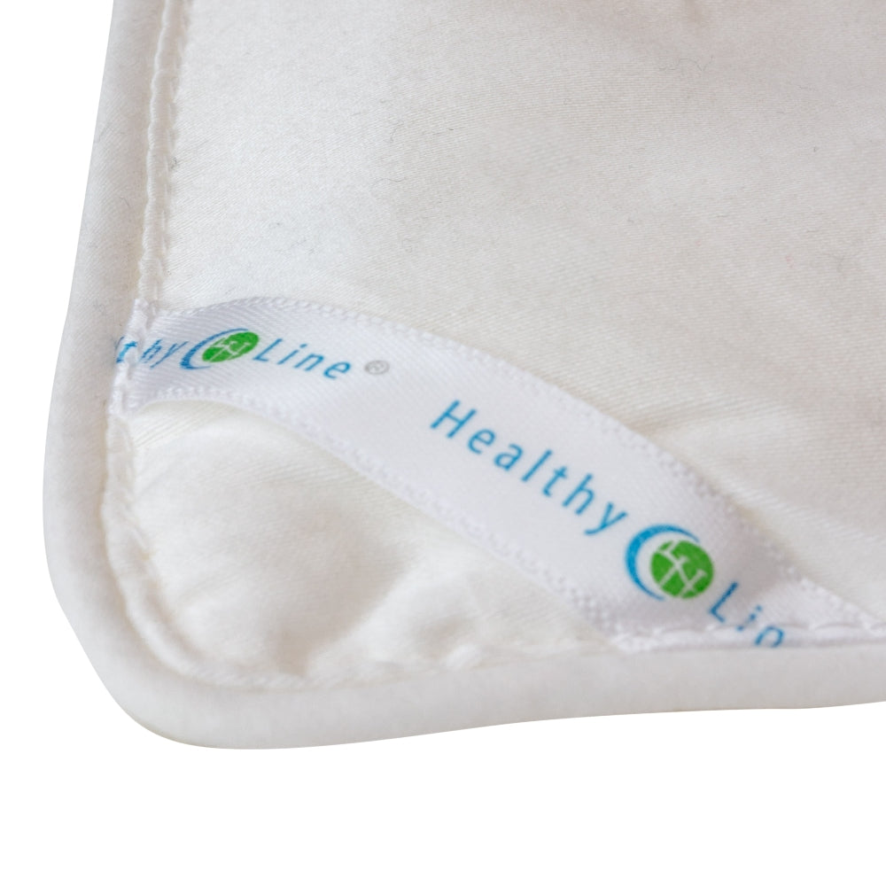 
                  
                    A white and blue HealthyLine Magnetic Energy Comforter box on a bed, highlighting natural silk and magnetic therapy
                  
                