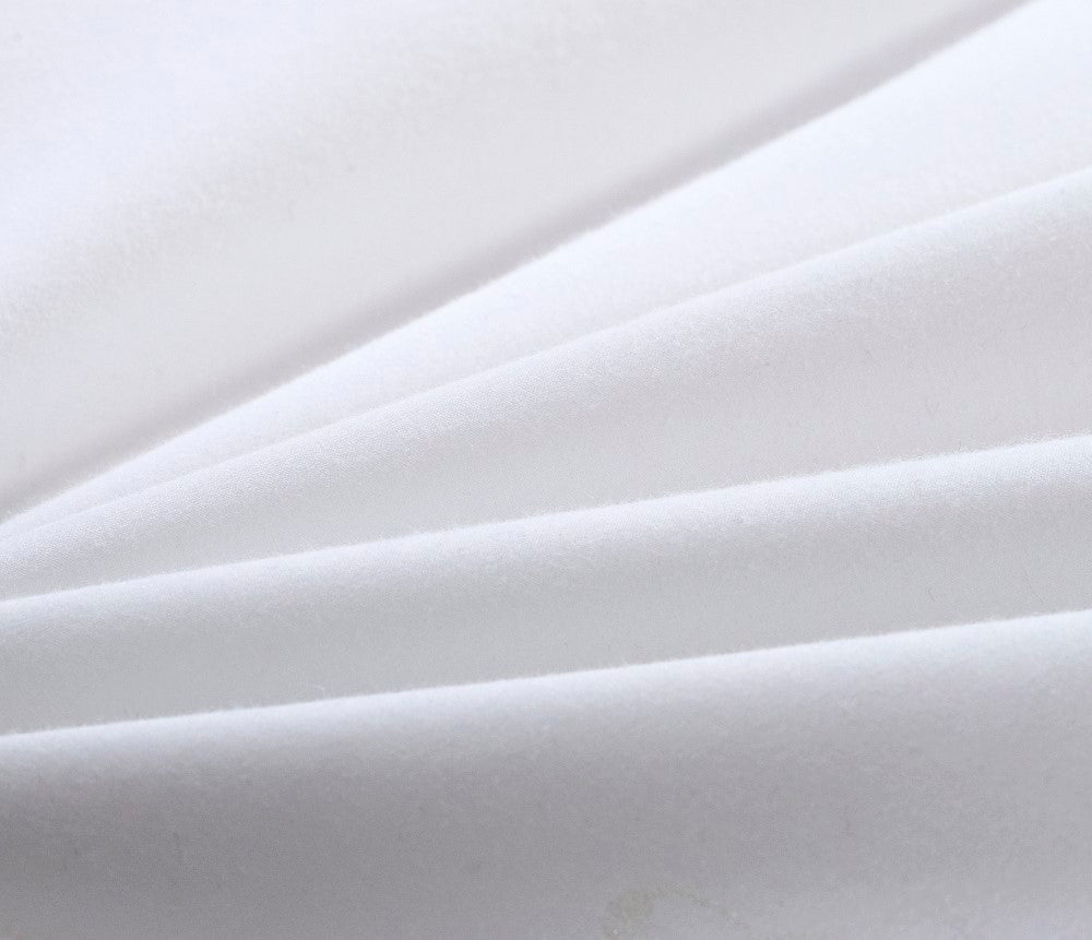 Extreme close-up of white HealthyLine quilt fabric, showing the soft, matte texture and high-quality thread weave
