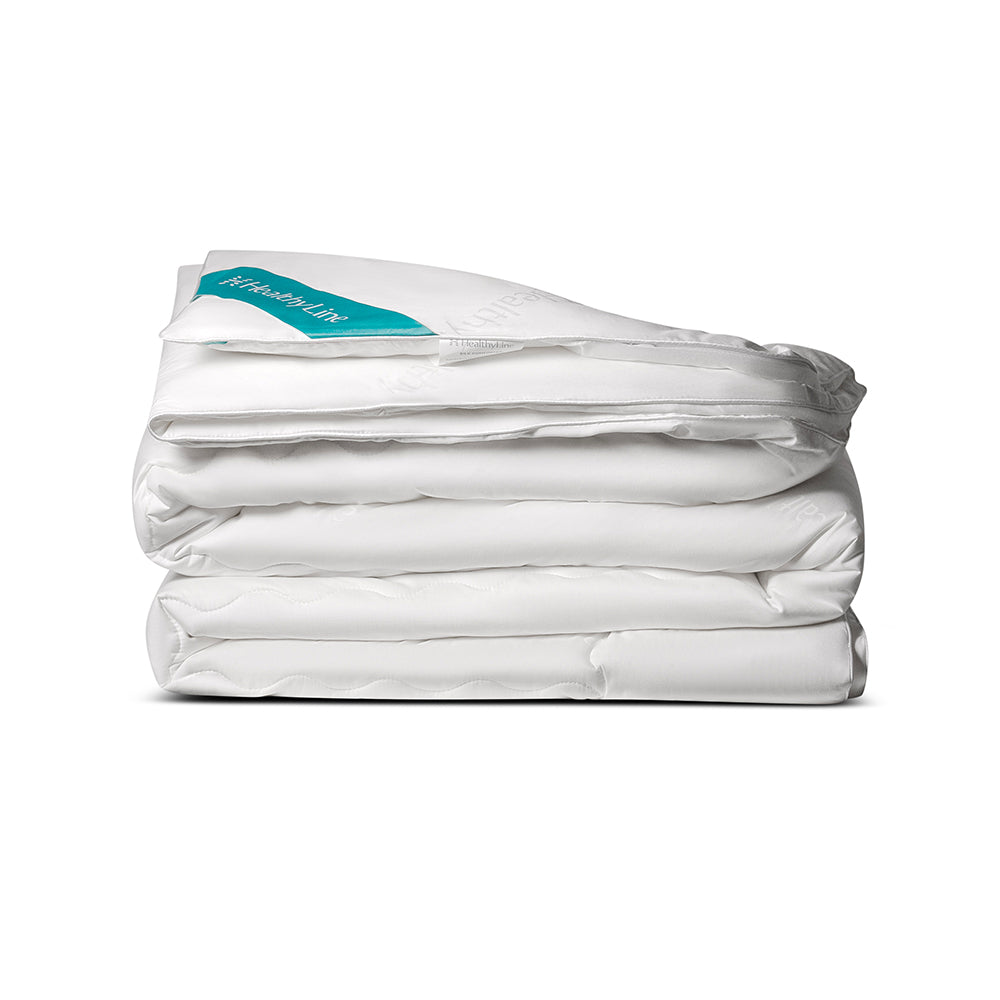 A white, quilted Magnetic Energy Comforter folded on a white background 
